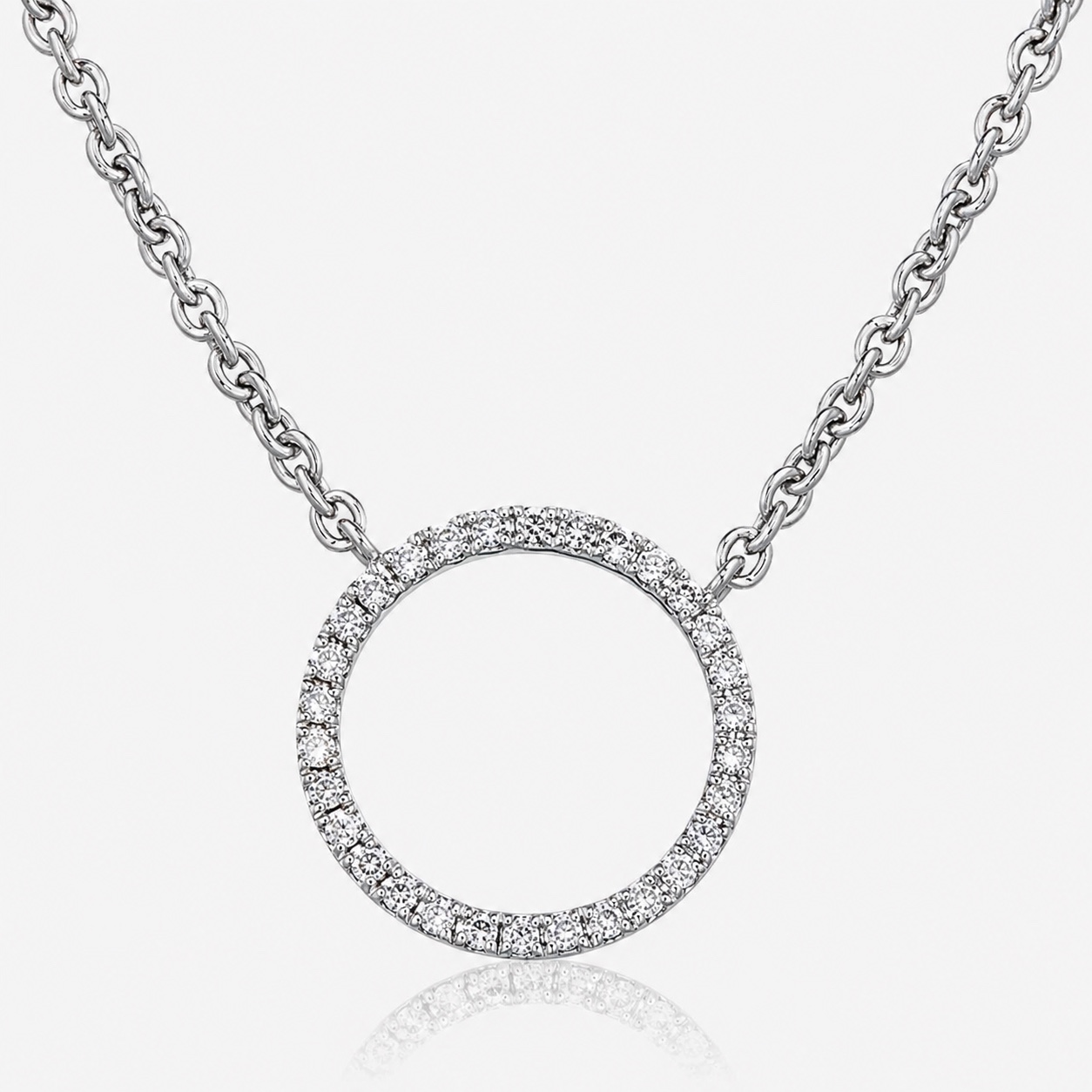 An 18ct white gold Circle of Life pendant, a full circle of grain-set round diamonds on a fine chain