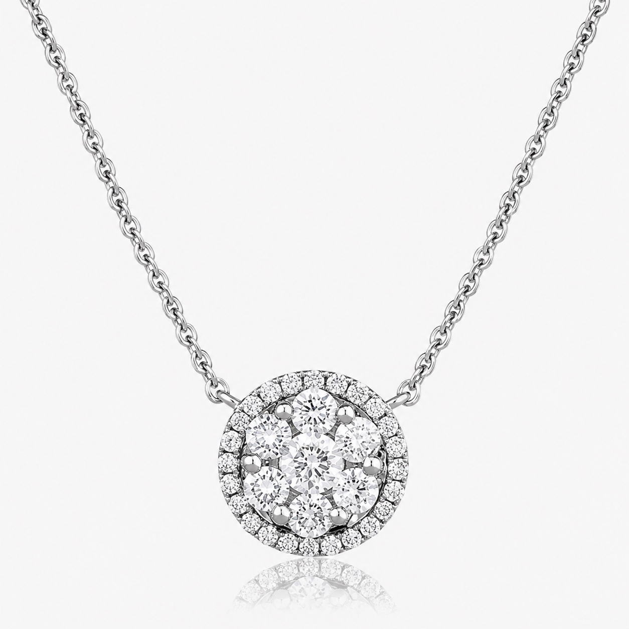 An 18ct white gold diamond cluster pendant, a brilliant-cut cluster within a diamond halo on a fine chain