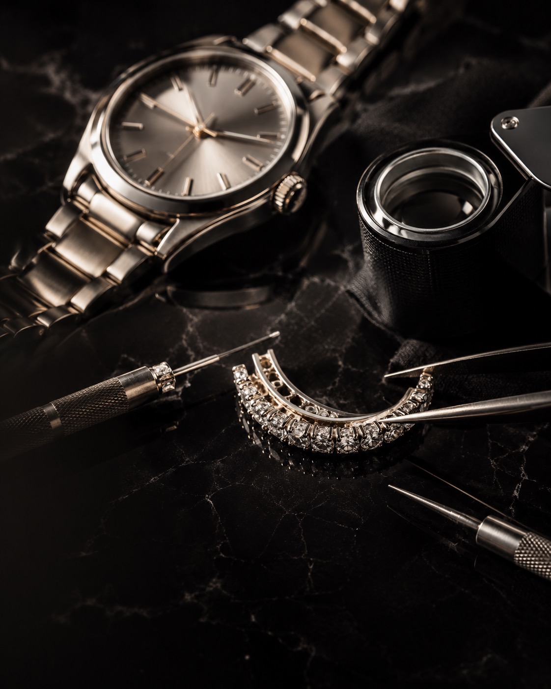 A wristwatch, watchmaker's tools and a diamond bracelet on the repair bench